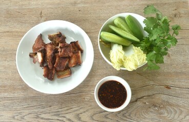 gilled slice pork bone on plate with vegetable dipping spicy chili tamarind sauce