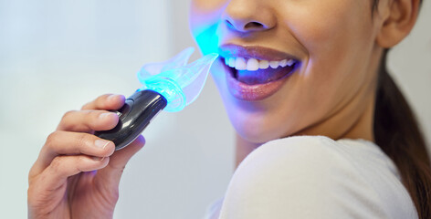 Teeth whitening, LED tool and mouth of patient, smile and treatment in office of dentist and...