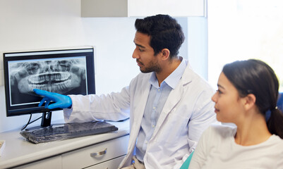 Dentist, consulting and x ray of teeth on computer for patient education, dental diagnosis and...