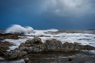 Wild, winter storm conditions at Kwaaiwater with ocean waves breaking onto the rocky Hermanus coastline. Whale Coast, Overberg, Western Cape, South Africa.
