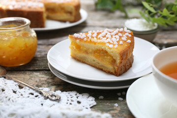 Orange jam sweet pie and cup of tea on wooden backgraund