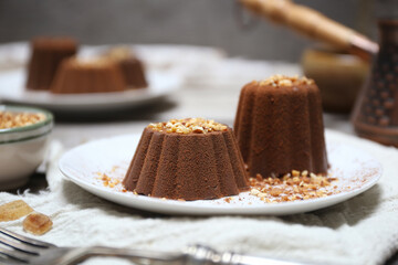 Chocolate panna cotta or Chocolate and milk jelly dessert, cocoa powder dressing and cup of coffee