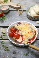 Tomato crumble with aromatic herbs and grated parmesan cheese