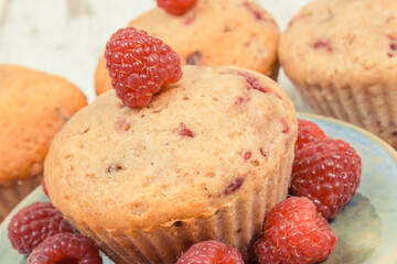 Fresh baked muffins with raspberries and chocolate. Delicious dessert for different occasion