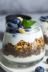 Granola with yogurt, chia and blueberries in a glass