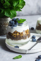 Granola with yogurt, chia and blueberries in a glass