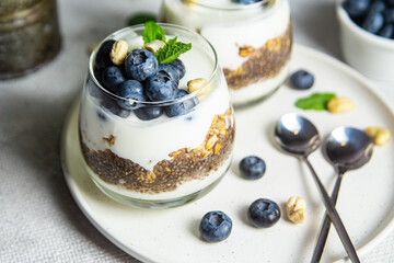 Granola with yogurt, chia and blueberries in a glass