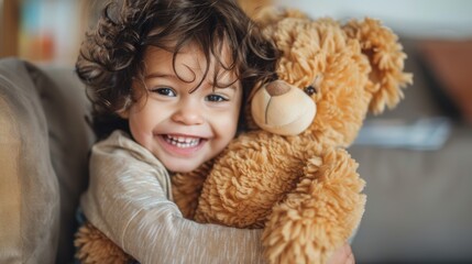A toddler playing with a plush toy, hugging it tightly with a big smile
