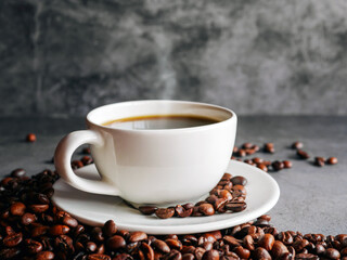 Coffee cup and coffee beans on  gray background, Black coffee cup aromatic