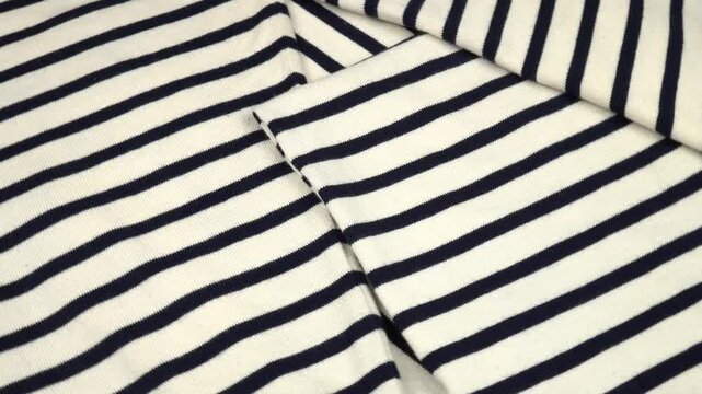 Thick folded randomly white fabric with thin black stripes, background