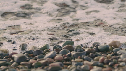 Beach Is Covered With Pebble. Small Sea Waves. Waves Crashing On A Beach.