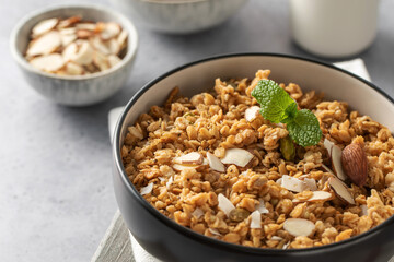 Crispy homemade granola with sliced almonds in a bowl. Healthy food