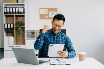 Businessman executive manager looking at laptop watching online webinar training or having virtual meeting video conference doing market research working