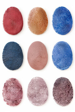 Nine colorful fingerprint textures in a grid, each in unique vibrant hues, ideal for security, identification, and pattern design concepts.