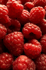 Macro photography of ripe raspberry berries. Fresh and appetizing berries. The photo is ideal for illustrating culinary projects, promotional materials and design.