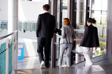 Businessmen walking and talking about work in the office.