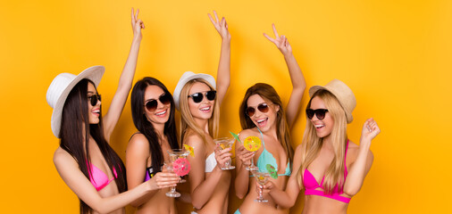 Crazy, funky, summer mood. Cheers to birthday girl Young five excited ladies are enjoing at the hen party near the swimpool in trendy swim wear and sunglasses, caps, having drinks to celebrate