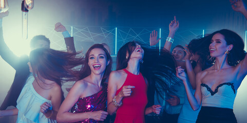 Low angle top view of fancy, style, trend, adorable, good-looking ladies in skirt, dress dance on party in night club raised hands up, closed eyes and laugh © deagreez