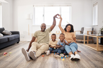 Black family, portrait and heart hands in home for love, security and protection in living room....