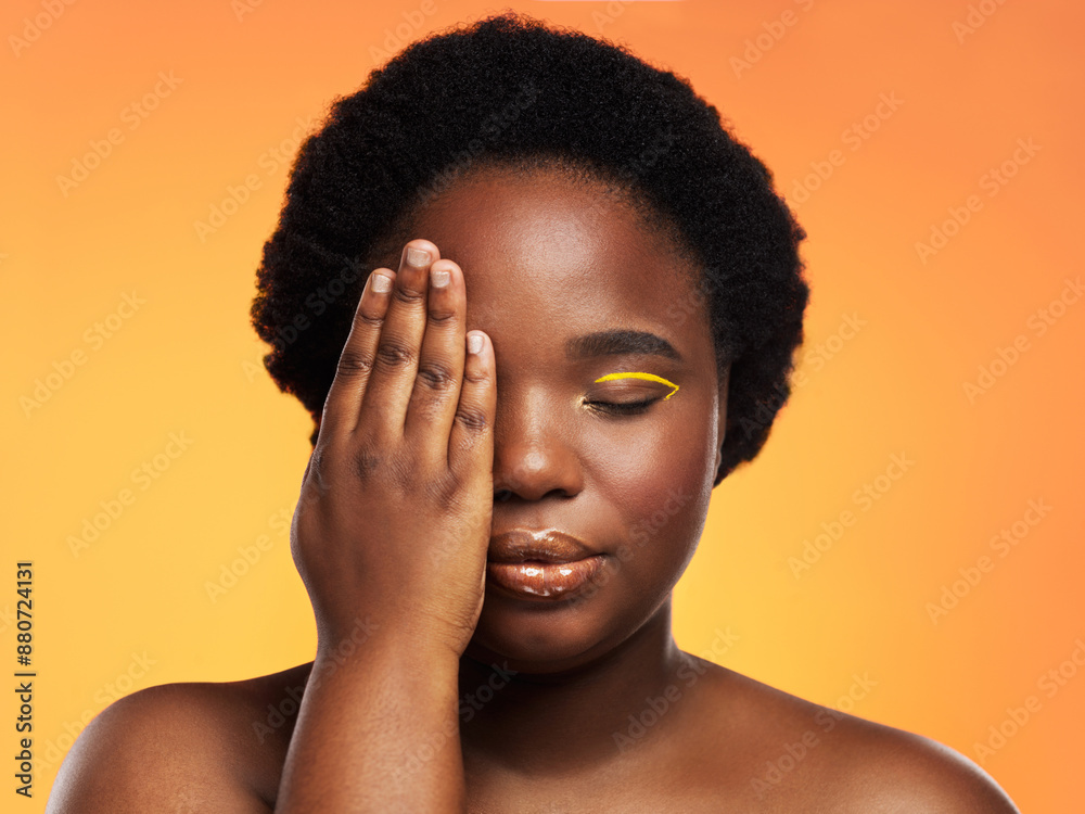 Sticker Black woman, makeup and hand on eye for beauty on studio background with cosmetics, afro and lip gloss. African girl, face and gold eyeliner with glow, shine and facial on backdrop for empowerment