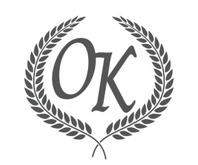 Initial letter O and K, OK monogram logo design with laurel wreath. Luxury calligraphy font.