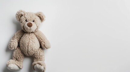 Obraz premium Simplified design featuring toy bear on white background Concept of caring for children and family Top view with copy space