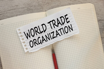 WORLD TRADE ORGANIZATION open notepad with text on torn paper