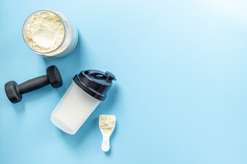 Protein shaker for sports nutrition. Whey protein powder in a scoop, top view