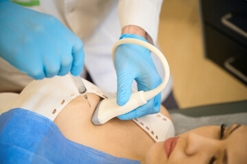 Doctor doing ultrasound-guided fine-needle aspiration cytology of mammary gland