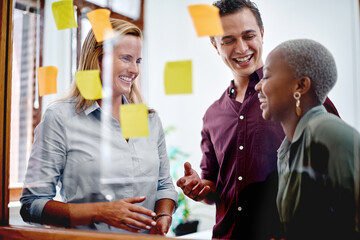 Business people, meeting and glass wall with sticky note for brainstorming, startup ideas and reminder in office. Employee group, moodboard and notes for planning project, development and teamwork - Powered by Adobe