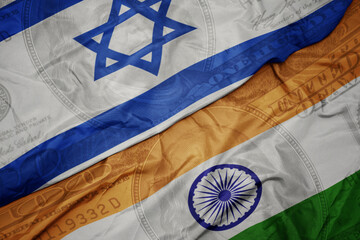 waving colorful flag of india and national flag of israel on the dollar money background. finance...