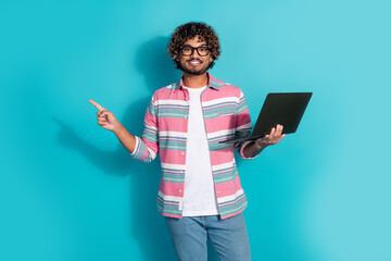Photo of funny positive multinational man wear trendy striped clothes empty space isolated on cyan...