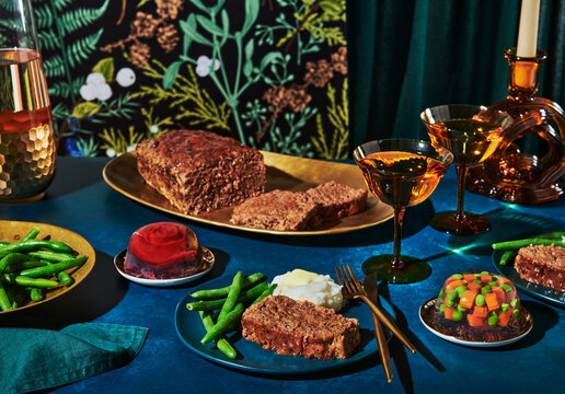 Vintage dinner party with meat loaf and vegetables 