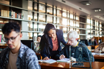 Female professor assisting student in library study session