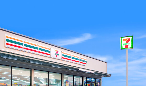 Samut Sakhon, Thailand - March 31, 2023 : 7 Eleven convenience store with logo sign pole against blue sky background, illustrative editorial