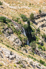 The scenic views of Gömbe Uçarsu Waterfall which  fly like a white cloud down the rocks at an altitude of about 50 meters, with a cave underneath, Gömbe, Kaş, Antalya