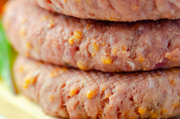 A piece of meat with a yellow cheese on it