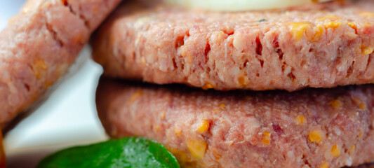 A piece of meat with a yellow cheese on it