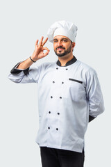 Indian Asian male chef, professional cook with ok, thumbs up, fist sign, isolated white background