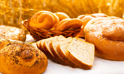 Lot of different flavored bread, wheat, rye, on the table in the field outside
