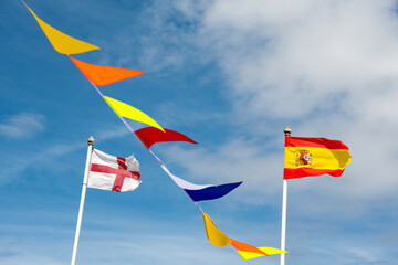 Euro 2024 concept image. Spanish flag of the winning team flies next to a tatty and faded English...