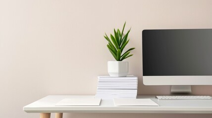 Modern minimalist workspace with computer, plant, and stacked books