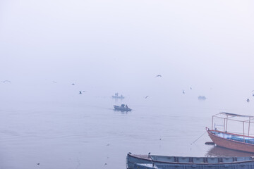 Boating in Varanasi, Tourists enjoying boat ride in the river ganges during the sunrise in river...
