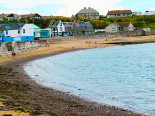 SCOTLAND 1 : People walking on the beach at Eyemouth, Scotland, UK, Europe