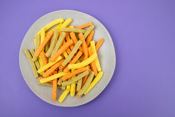 Potato vegetable chips baked with herbs on dish