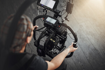 Photographer, camera and shooting with stabilizing rig on set for photography, media and magazine. Cameraman, focus and person backstage for filming, production and equipment as director with lens