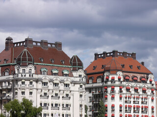 Two beautiful buildings against cloudy sky