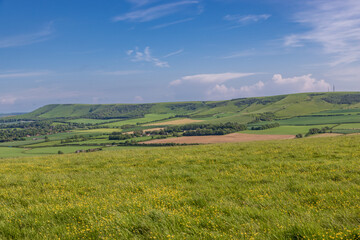 Obraz premium A view over to Firle Beacon from near Glynde in Sussex, with a blue sky overhead