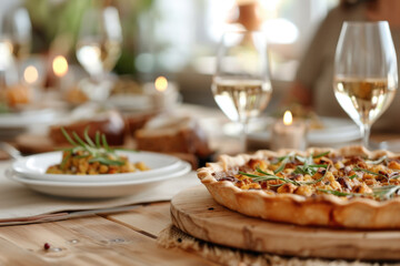 Thanksgiving family dinner. Traditional apple pie and vegan meal close up, with blurred happy people around the table celebrating the holiday.	
