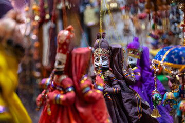 Fototapeta premium Interior decoration, Handmade colorful hanging puppets for decoration on display at shop. Selective focus.